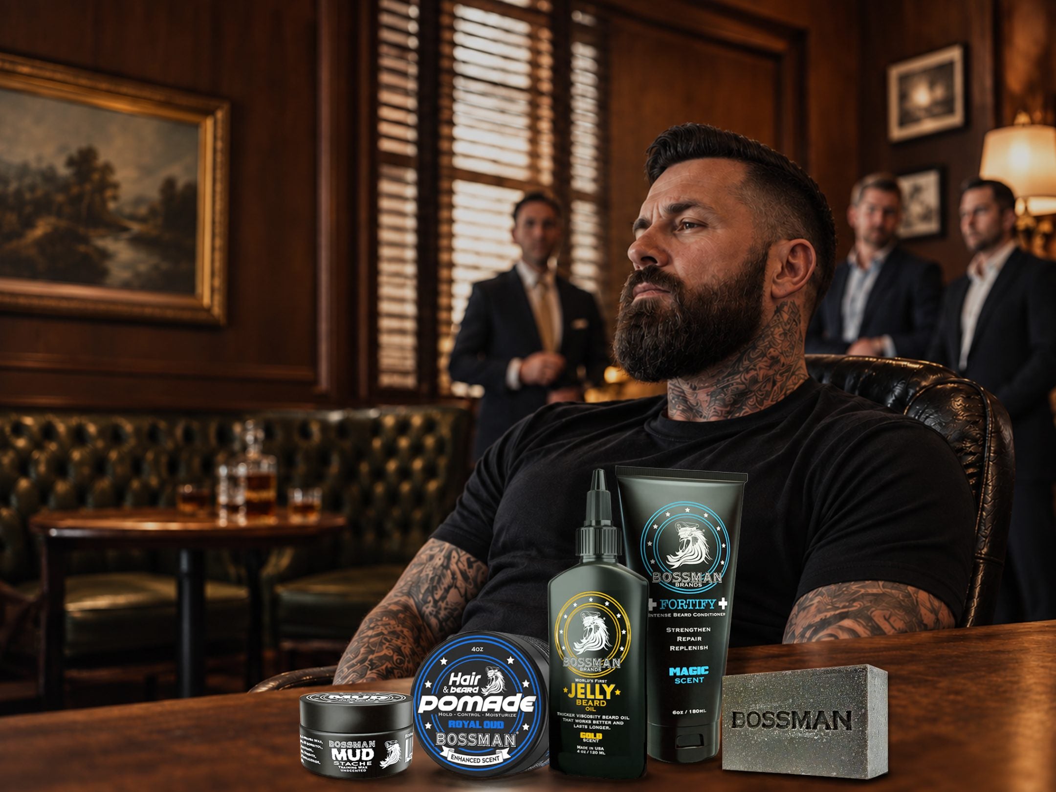 A bearded man in a dark bar room, with five Bossman products on the bar top in front of him